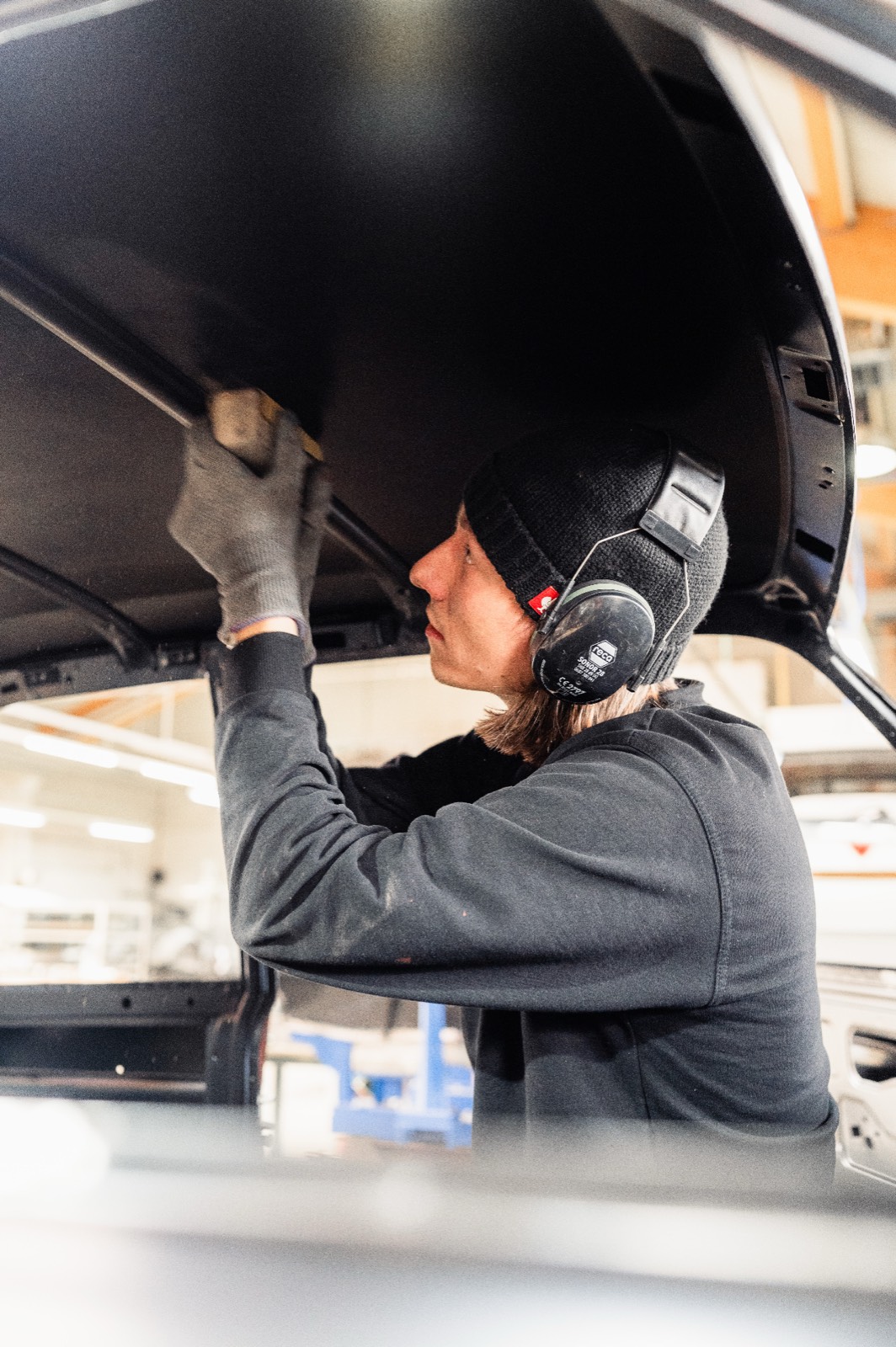 Craftsman fitting body panels on BMW 2002