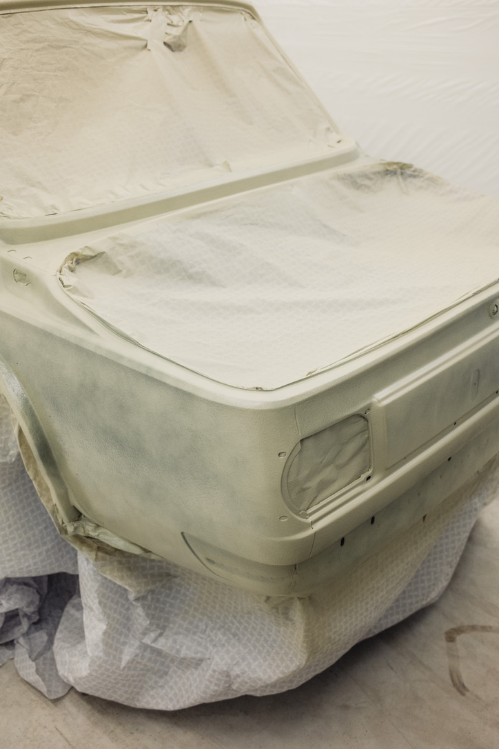 BMW 2002 body in primer stage with masked areas in paint booth